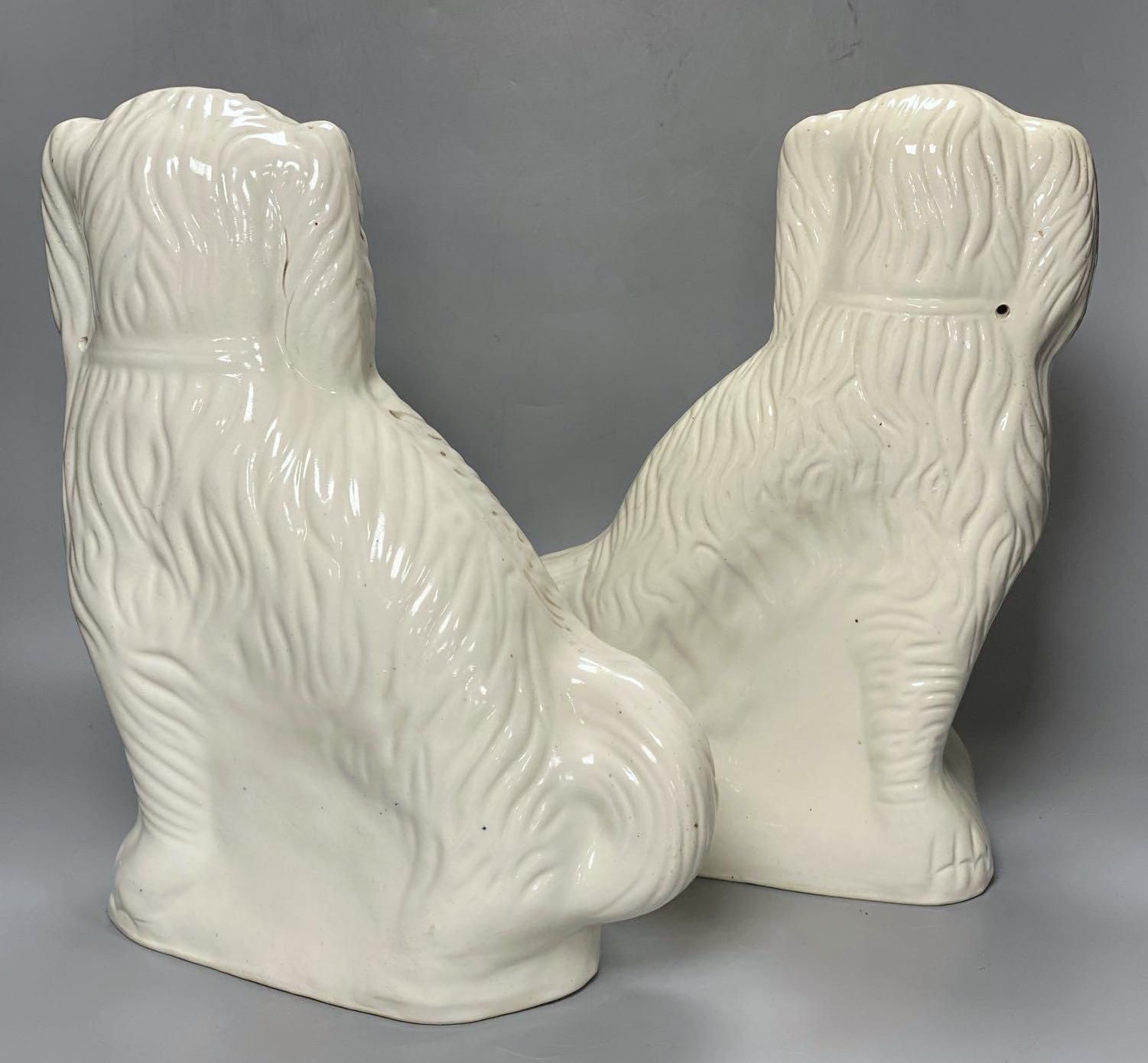 A large pair of Victorian Staffordshire pottery comforter spaniels, 39cm and a pair of Royal Doulton comforter spaniels, 14cm